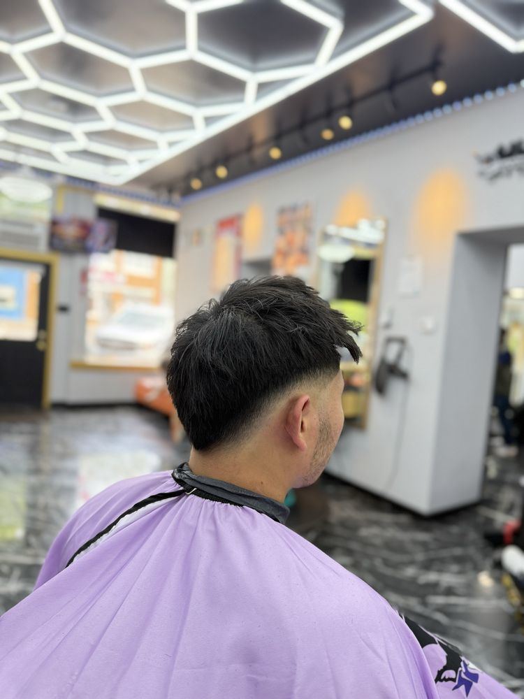 Textured crop with a drop fade, under the shop’s hexagon ceiling lights